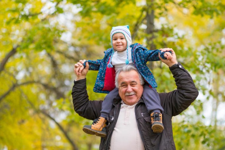 grandfather with child on shoulders