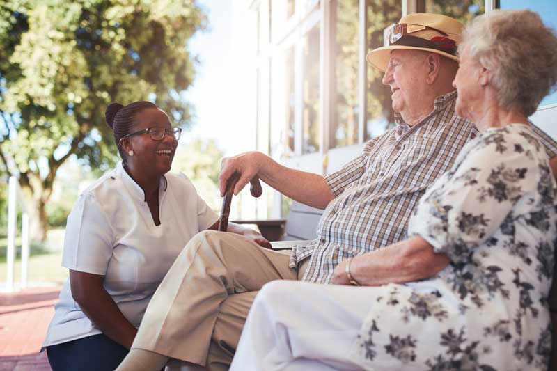 Woman discussing nursing care options with senior couple